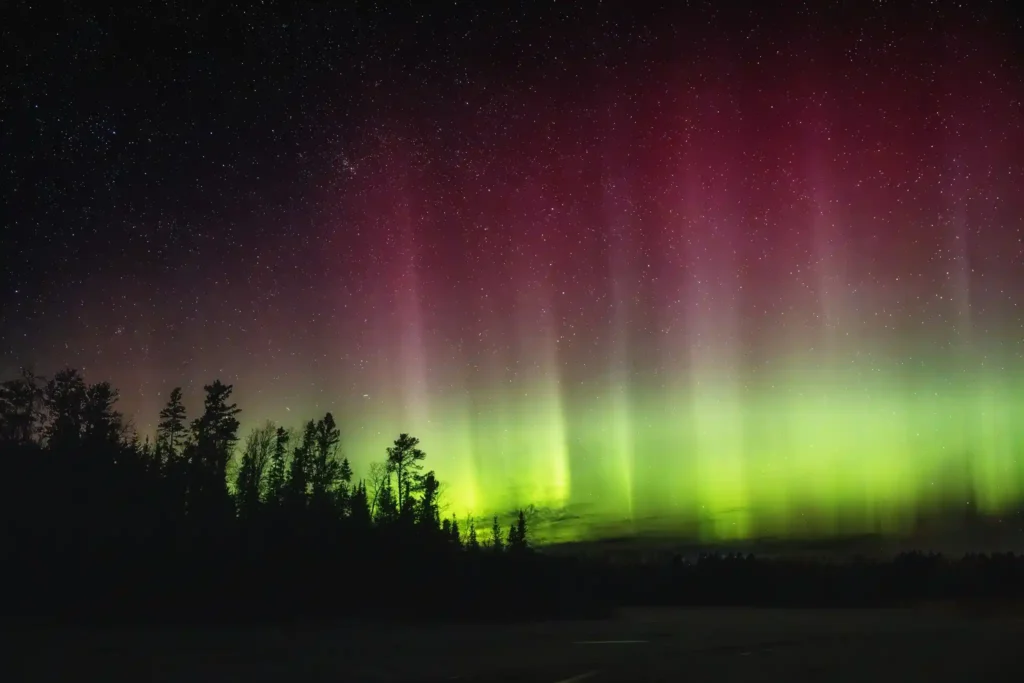 a green and purple aurora bore in the night sky